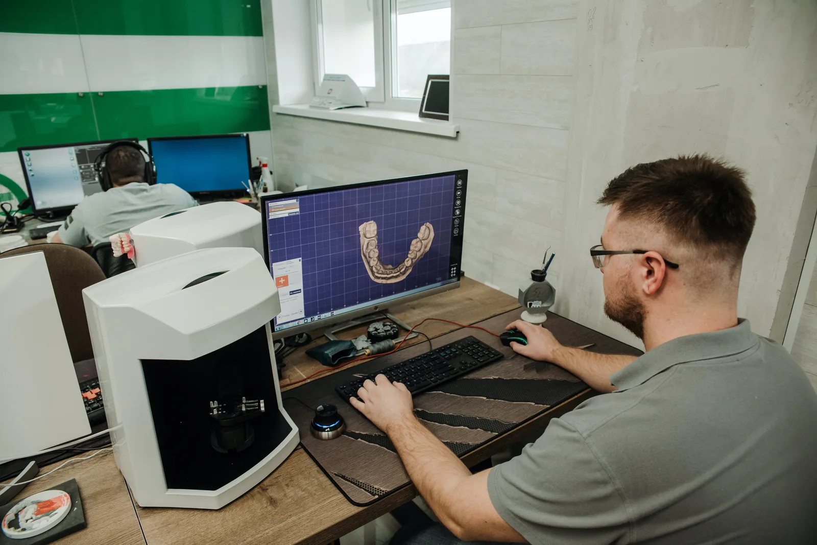 Technician using dental design software